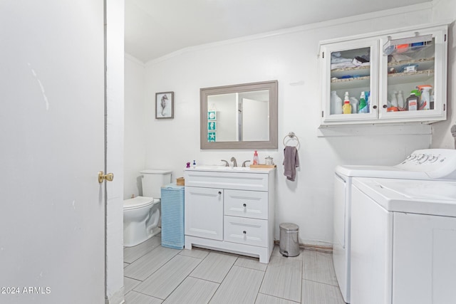 bathroom with vanity, toilet, washer and clothes dryer, and crown molding