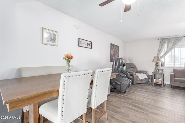 dining space featuring ceiling fan, a textured ceiling, and light wood-type flooring