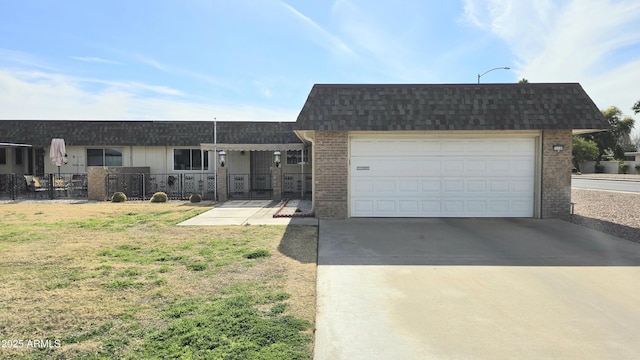 ranch-style home featuring a garage and a front lawn