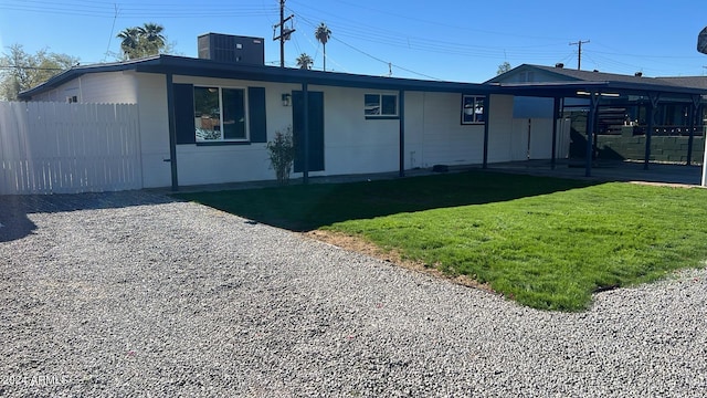 view of front facade with a front yard and central AC unit