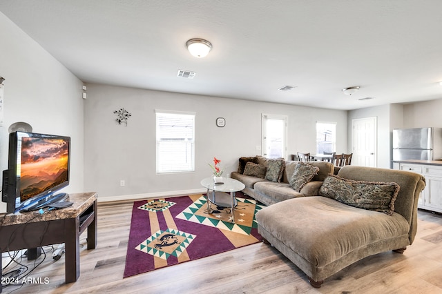 living room with light hardwood / wood-style flooring