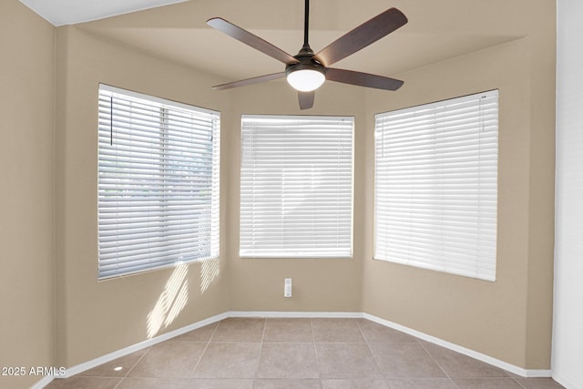 5252 W Pontiac Dr, Glendale, AZ 85308 - unfurnished room with light tile patterned floors, baseboards, a ceiling fan, and plenty of natural light