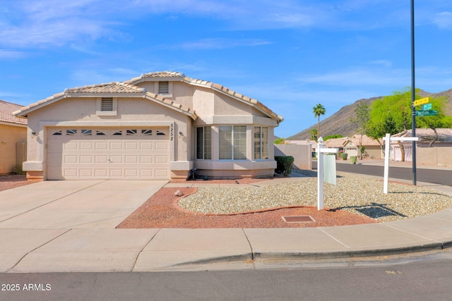 5252 W Pontiac Dr, Glendale, AZ 85308 - ranch-style house featuring an attached garage, a tiled roof, a mountain view, and driveway