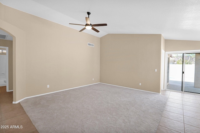 5252 W Pontiac Dr, Glendale, AZ 85308 - unfurnished room featuring visible vents, light tile patterned floors, arched walkways, a ceiling fan, and lofted ceiling