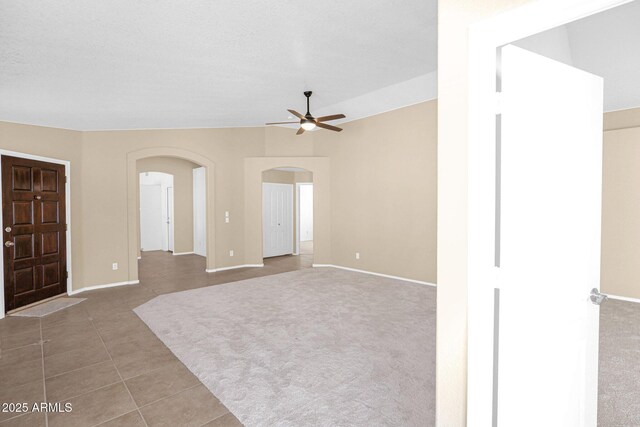 5252 W Pontiac Dr, Glendale, AZ 85308 - interior space with tile patterned floors, arched walkways, baseboards, and ceiling fan