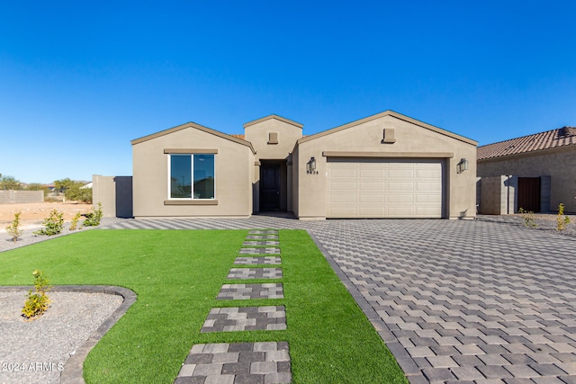 view of front of house with a garage and a front yard