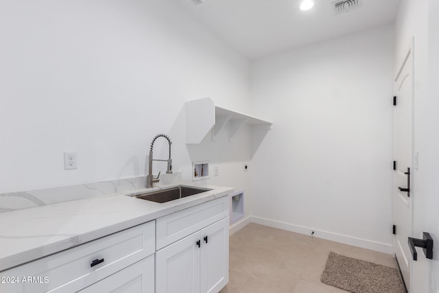 laundry room with cabinets, washer hookup, hookup for an electric dryer, and sink