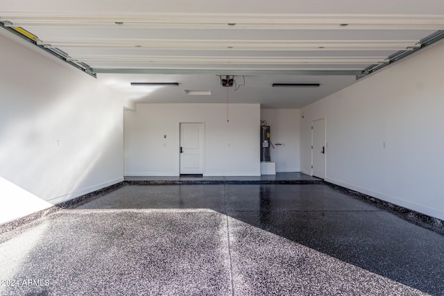 garage featuring a garage door opener and electric water heater