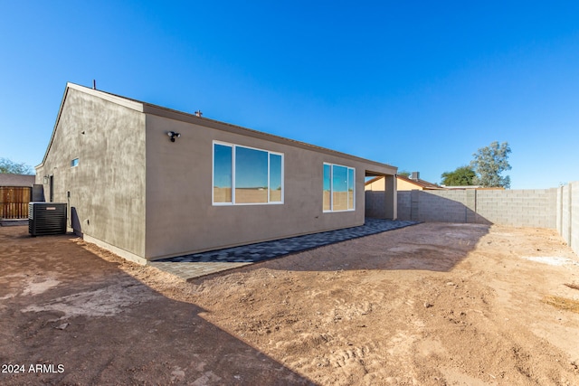 back of property featuring central AC