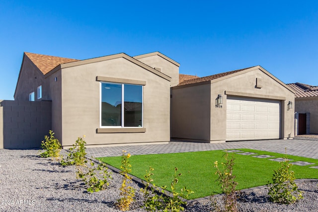 view of front of house with a garage and a front yard