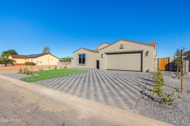 ranch-style house with a garage and a front yard