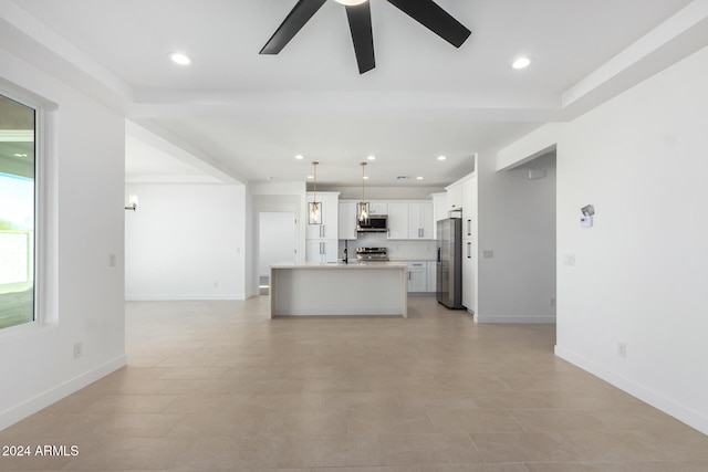 kitchen featuring stainless steel appliances, a center island with sink, ceiling fan, hanging light fixtures, and white cabinets