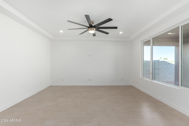 empty room with light tile patterned floors and ceiling fan