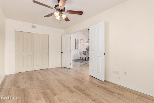 unfurnished bedroom with a closet, ceiling fan, and light wood-type flooring