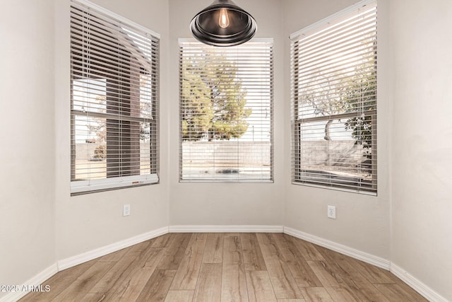 unfurnished room featuring hardwood / wood-style floors and a wealth of natural light