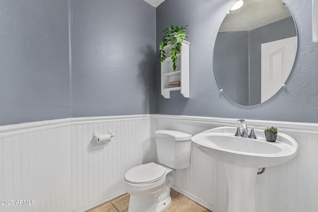 bathroom featuring sink, tile patterned floors, and toilet