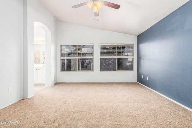 empty room with ceiling fan, lofted ceiling, and carpet floors