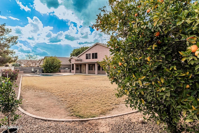 rear view of property featuring a patio area