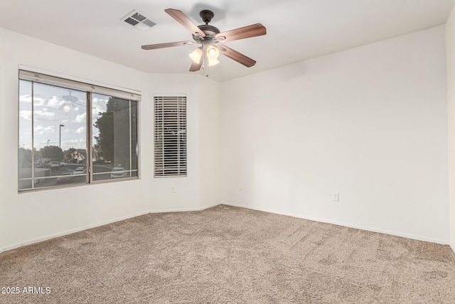 unfurnished room with ceiling fan and carpet