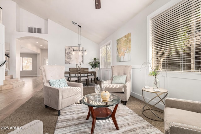 living room featuring hardwood / wood-style flooring and high vaulted ceiling