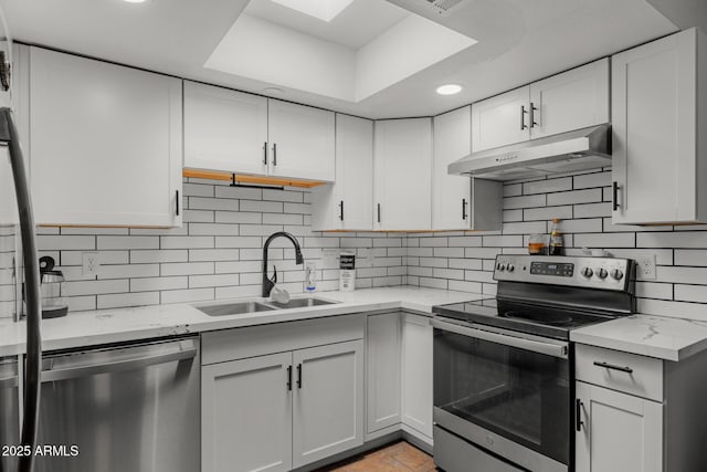 6008 W Augusta Ave, Glendale, AZ 85301 - kitchen featuring appliances with stainless steel finishes, under cabinet range hood, light stone counters, backsplash, and recessed lighting