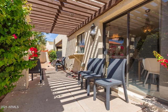 view of patio with a pergola and fence