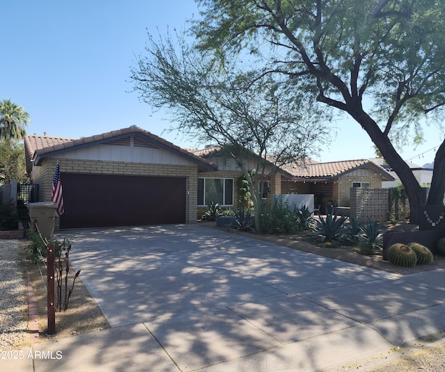 402 E Claremont St, Phoenix, AZ 85012 - single story home featuring an attached garage, concrete driveway, and a tiled roof