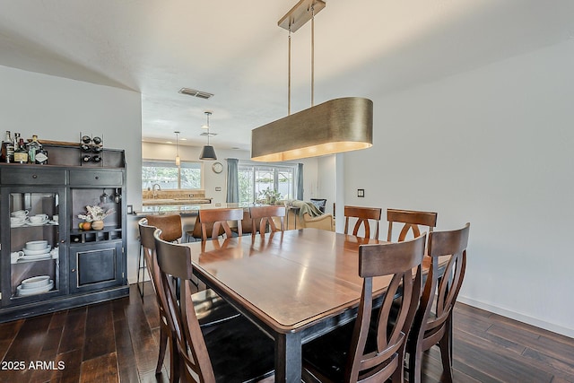 402 E Claremont St, Phoenix, AZ 85012 - dining area with dark wood-style floors and baseboards