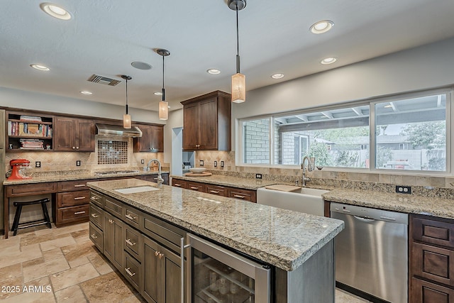 402 E Claremont St, Phoenix, AZ 85012 - kitchen with appliances with stainless steel finishes, wine cooler, a sink, backsplash, and recessed lighting
