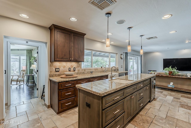 402 E Claremont St, Phoenix, AZ 85012 - kitchen with beverage cooler, recessed lighting, backsplash, stone tile floors, and dark brown cabinetry