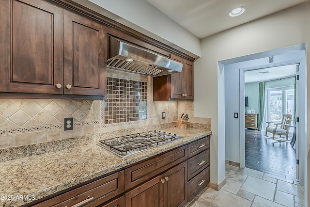 402 E Claremont St, Phoenix, AZ 85012 - kitchen with range hood, stainless steel gas stovetop, baseboards, backsplash, and dark brown cabinetry