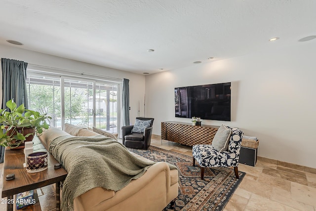 402 E Claremont St, Phoenix, AZ 85012 - living room with stone tile floors, baseboards, and recessed lighting