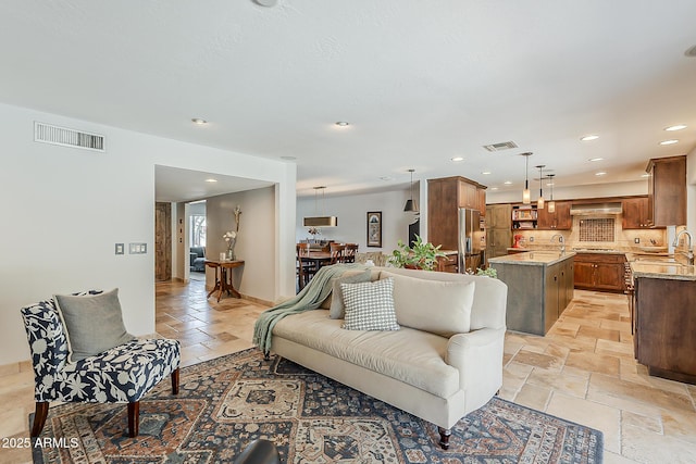 402 E Claremont St, Phoenix, AZ 85012 - living room featuring stone tile floors and recessed lighting