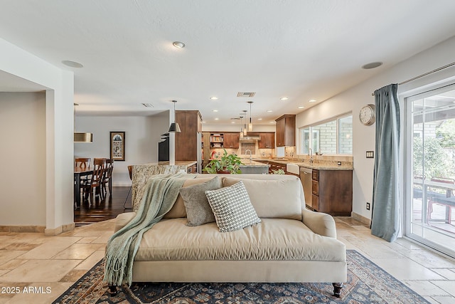 402 E Claremont St, Phoenix, AZ 85012 - living room with healthy amount of natural light, baseboards, stone tile flooring, and recessed lighting