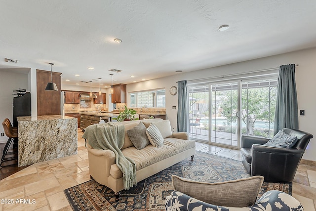402 E Claremont St, Phoenix, AZ 85012 - living area with stone tile floors and recessed lighting