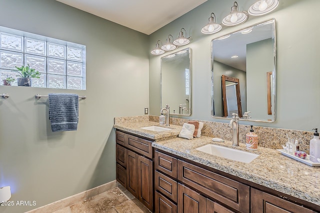 402 E Claremont St, Phoenix, AZ 85012 - bathroom with double vanity, baseboards, and stone finish floors