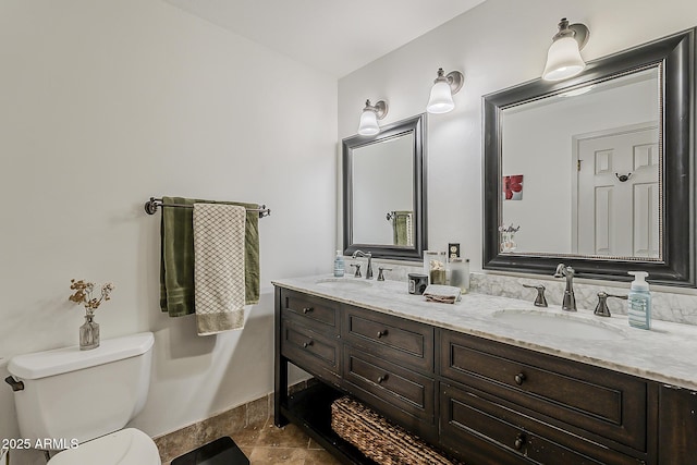 402 E Claremont St, Phoenix, AZ 85012 - bathroom with double vanity, toilet, and baseboards