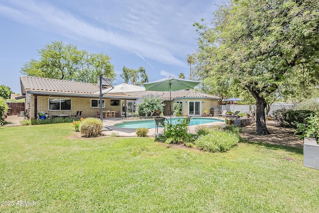 402 E Claremont St, Phoenix, AZ 85012 - back of house featuring a tile roof, a patio area, and brick siding