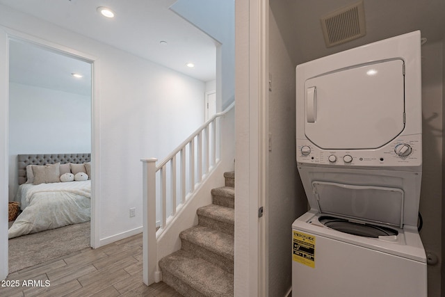 9835 E Wavelength Ave, Mesa, AZ 85212 - laundry room with light wood-type flooring, visible vents, recessed lighting, baseboards, and stacked washer / drying machine