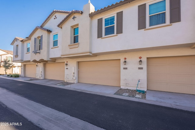 9835 E Wavelength Ave, Mesa, AZ 85212 - view of front of home featuring an attached garage, a chimney, stucco siding, and a tile roof
