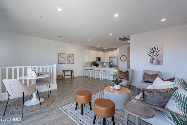 9835 E Wavelength Ave, Mesa, AZ 85212 - living area featuring light wood finished floors, visible vents, and recessed lighting