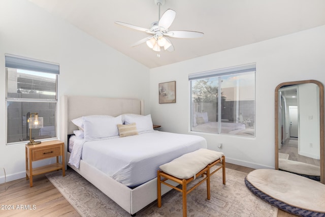 bedroom featuring hardwood / wood-style floors, vaulted ceiling, and ceiling fan