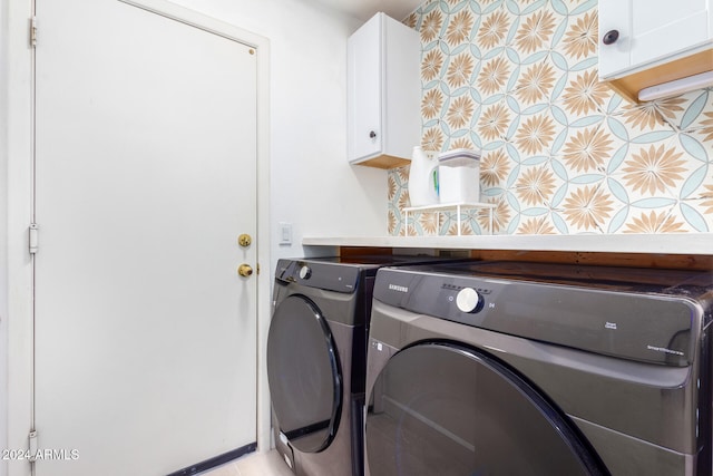 washroom featuring cabinets and washing machine and dryer