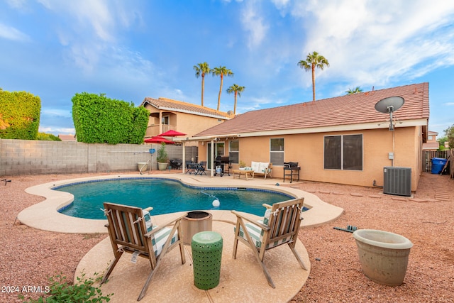 view of pool featuring a patio area, central AC, and grilling area