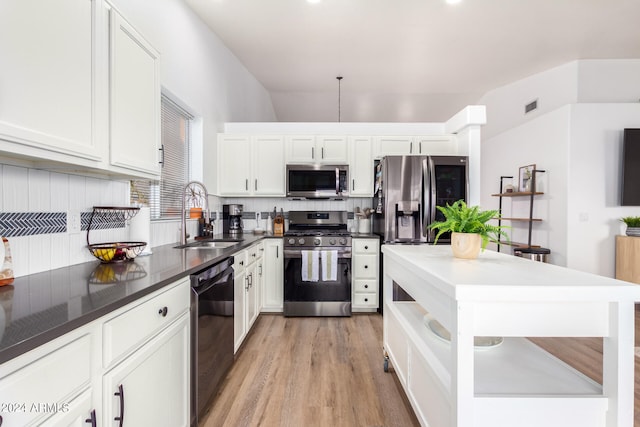 kitchen with light hardwood / wood-style flooring, appliances with stainless steel finishes, sink, and white cabinets