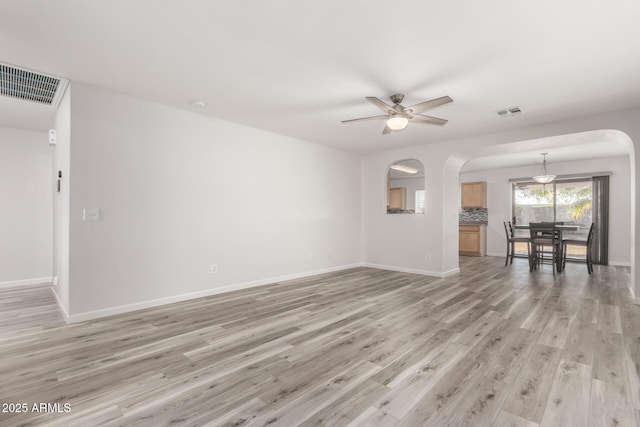 unfurnished living room featuring ceiling fan and light hardwood / wood-style floors