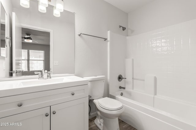 full bathroom featuring shower / bathtub combination, vanity, ceiling fan, wood-type flooring, and toilet