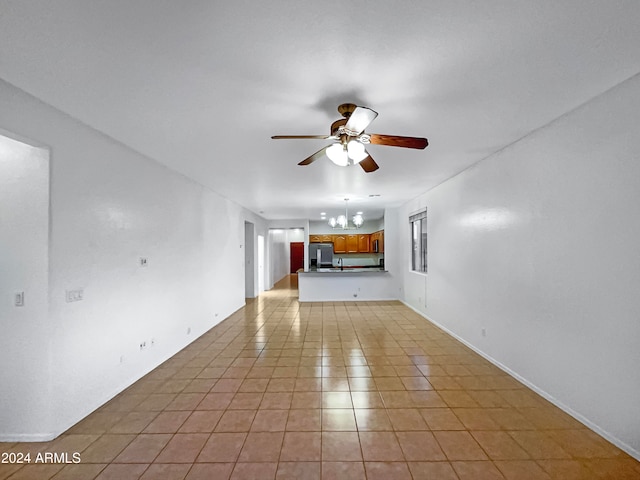 unfurnished living room with light tile patterned floors and ceiling fan with notable chandelier