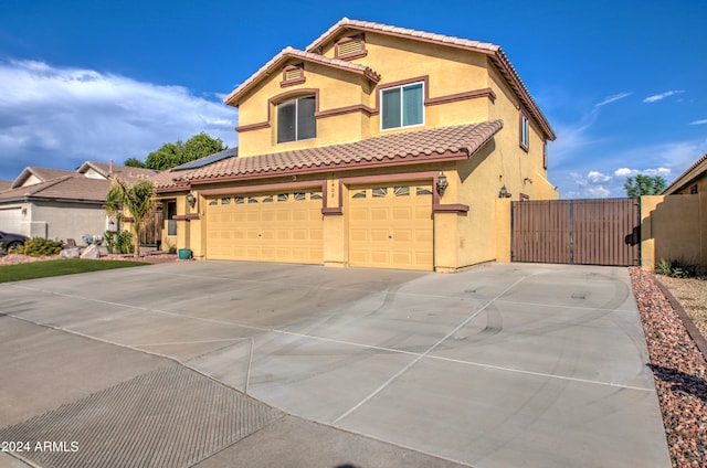 mediterranean / spanish home featuring a garage