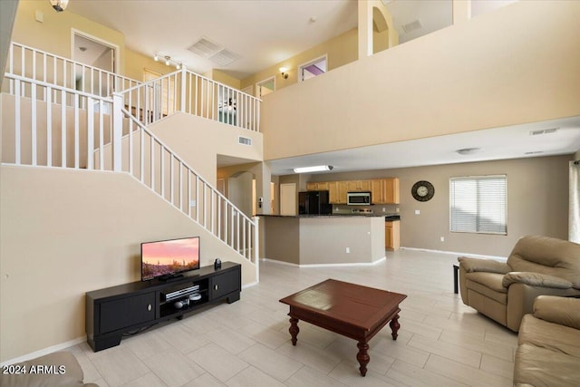 living room featuring a towering ceiling